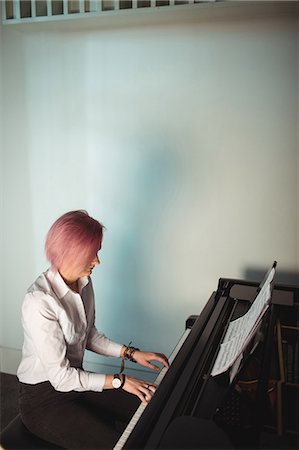 simsearch:6109-08764714,k - Woman playing a piano in music studio Stock Photo - Premium Royalty-Free, Code: 6109-08764722