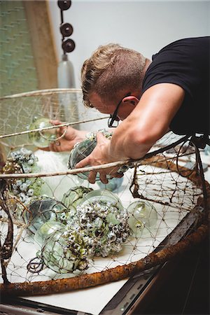 simsearch:614-08821252,k - Glassblower examining glassware at glassblowing factory Stock Photo - Premium Royalty-Free, Code: 6109-08764853