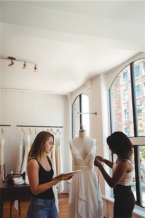 simsearch:6109-08764888,k - Female fashion designers working on digital tablet in the studio Stock Photo - Premium Royalty-Free, Code: 6109-08764866