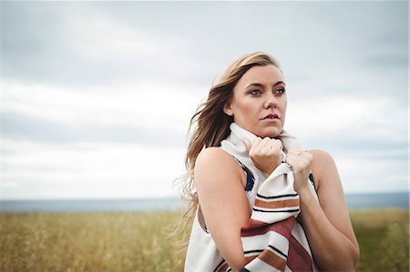 Woman standing in the field feeling the breeze Stock Photo - Premium Royalty-Free, Code: 6109-08764817