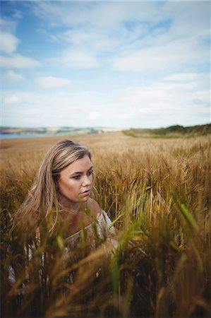 simsearch:6118-08220580,k - Woman touching wheat crop in field on a sunny day Stock Photo - Premium Royalty-Free, Code: 6109-08764832