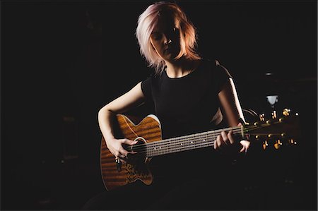 simsearch:6109-08764998,k - Female student playing guitar in a studio Stock Photo - Premium Royalty-Free, Code: 6109-08765006
