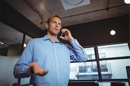 simsearch:693-08769289,k - Business man talking on the mobile phone in office Stock Photo - Premium Royalty-Free, Code: 6109-08765170