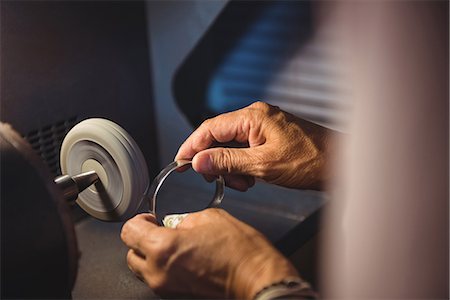 simsearch:6115-06967231,k - Hands of craftswoman working on a machine in workshop Stock Photo - Premium Royalty-Free, Code: 6109-08765230