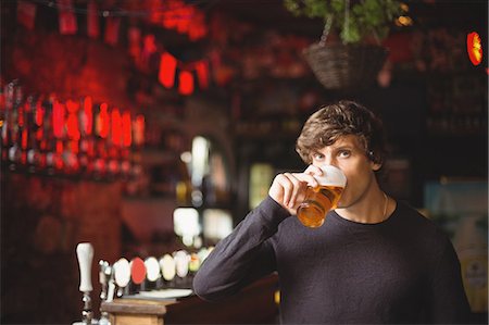 simsearch:6109-08782623,k - Portrait of man having a glass of beer at bar Stock Photo - Premium Royalty-Free, Code: 6109-08782695