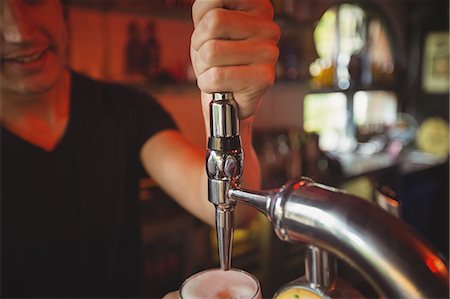 simsearch:859-06537790,k - Close-up of bar tender filling beer from bar pump at bar counter Photographie de stock - Premium Libres de Droits, Code: 6109-08782632