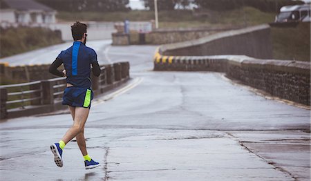 simsearch:6109-08928512,k - Athlete running on road during the day Stock Photo - Premium Royalty-Free, Code: 6109-08782856