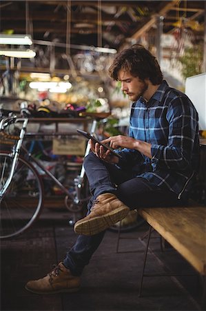 Man using digital tablet in workshop Stock Photo - Premium Royalty-Free, Code: 6109-08783016