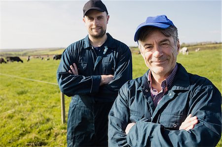 pasture - Portrait of confident farm workers standing on grassy field Stock Photo - Premium Royalty-Free, Code: 6109-08700385