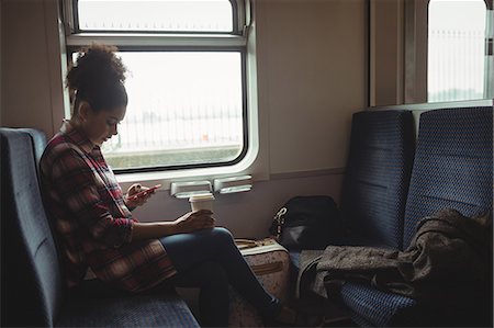 simsearch:6109-08700198,k - Side view of young woman using phone while sitting in train Foto de stock - Sin royalties Premium, Código: 6109-08700302