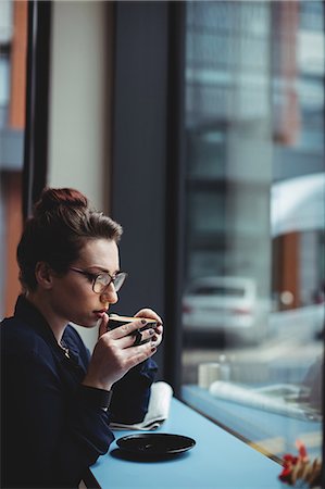 elegant cafe interiors - Thoughtful businesswoman drinking coffee in cafe Stock Photo - Premium Royalty-Free, Code: 6109-08700449