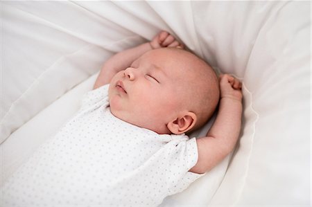 Newborn baby sleeping in moses basket at home Stock Photo - Premium Royalty-Free, Code: 6109-08700766