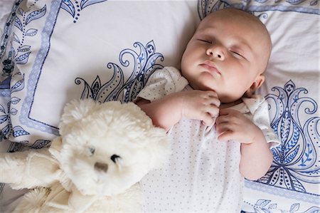 simsearch:6109-06194925,k - Baby sleeping on bed with teddy bear in bedroom at home Stock Photo - Premium Royalty-Free, Code: 6109-08700776