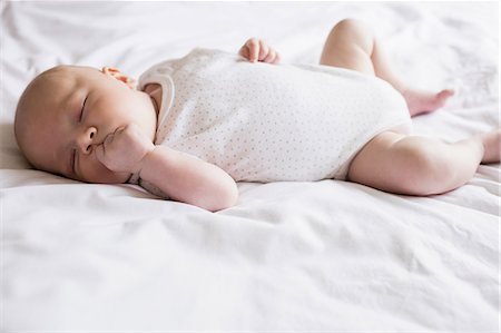 simsearch:6109-08489144,k - Baby sleeping on bed in bedroom at home Stock Photo - Premium Royalty-Free, Code: 6109-08700780