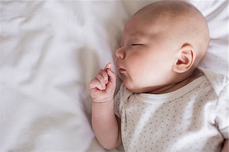 simsearch:6109-08489144,k - Baby sleeping on bed in bedroom at home Stock Photo - Premium Royalty-Free, Code: 6109-08700781