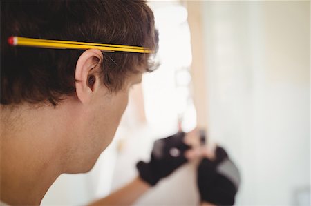 simsearch:6109-08536978,k - Carpenter with pencil on his ear while working at home Stock Photo - Premium Royalty-Free, Code: 6109-08701004