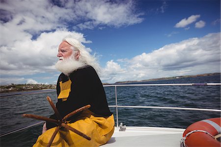 past time - Thoughtful fisherman sitting on fishing boat Stock Photo - Premium Royalty-Free, Code: 6109-08701029