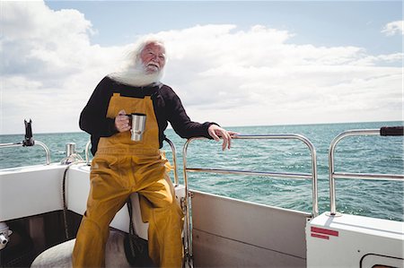 pictures of elderly people being active - Fisherman drinking cup of coffee on boat Foto de stock - Sin royalties Premium, Código: 6109-08701112