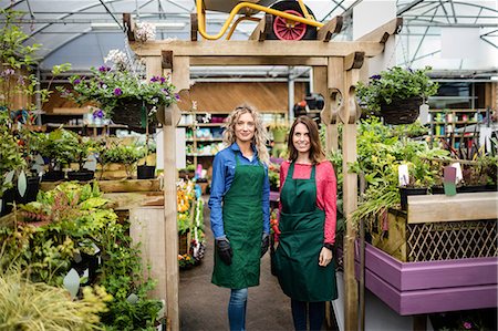 simsearch:6109-08701225,k - Portrait of female florists standing together at garden centre Stock Photo - Premium Royalty-Free, Code: 6109-08701127