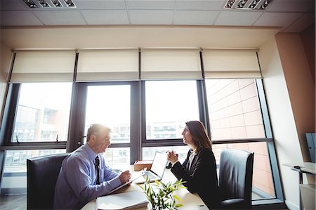 elegant computer - Businessman into discussion with colleague in office Stock Photo - Premium Royalty-Free, Code: 6109-08701307