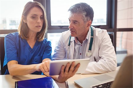 pic of medical staff - Doctor discussing with nurse over digital tablet at the hospital Stock Photo - Premium Royalty-Free, Code: 6109-08701323