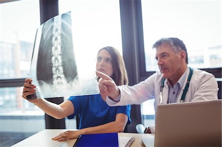 doctor looking at xray - Doctor and nurse examining x-ray at the hospital Stock Photo - Premium Royalty-Free, Code: 6109-08701326