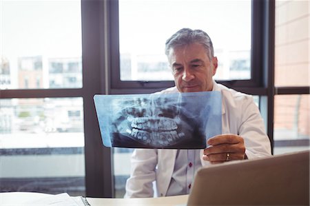 doctor looking at xray - Doctor examining x-ray at the hospital Stock Photo - Premium Royalty-Free, Code: 6109-08701331