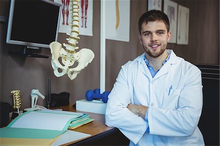 Portrait of physiotherapist sitting at his desk in the clinic Stockbilder - Premium RF Lizenzfrei, Bildnummer: 6109-08701768