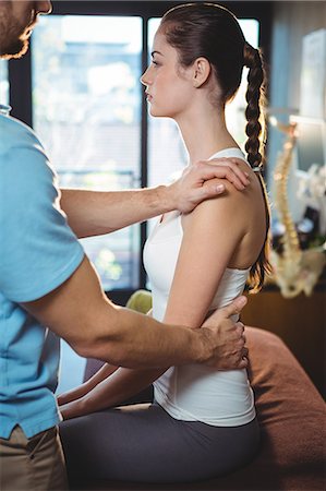 simsearch:6109-08701718,k - Physiotherapist massaging the back of a female patient in the clinic Stock Photo - Premium Royalty-Free, Code: 6109-08701785