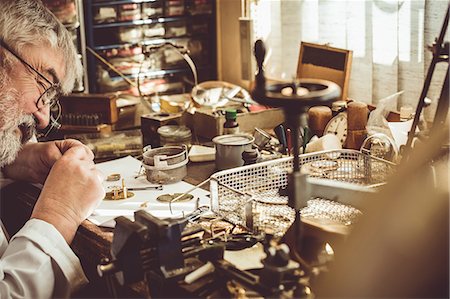 Horologist repairing a watch in the workshop Stock Photo - Premium Royalty-Free, Code: 6109-08705167