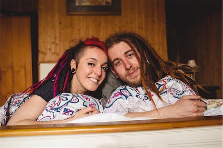 Portrait of young hipster couple relaxing on bed at home Stock Photo - Premium Royalty-Free, Code: 6109-08705136