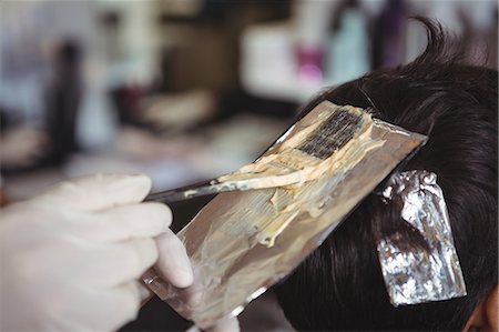 Hairdresser dyeing hair of client at a salon Stock Photo - Premium Royalty-Free, Code: 6109-08705267