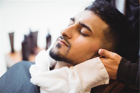 Barber applying a hot towel on a client face in barber shop Photographie de stock - Premium Libres de Droits, Code: 6109-08705355