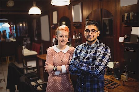 salon owner - Portrait of two barbers standing with arm crossed in barber shop Stock Photo - Premium Royalty-Free, Code: 6109-08705371