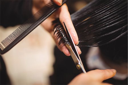 simsearch:6109-08705418,k - Man getting his hair trimmed with scissor in barber shop Foto de stock - Sin royalties Premium, Código: 6109-08705382