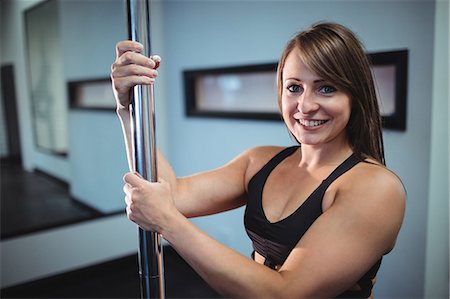 polish ethnicity (female) - Portrait of pole dancer holding pole in fitness studio Stock Photo - Premium Royalty-Free, Code: 6109-08705425