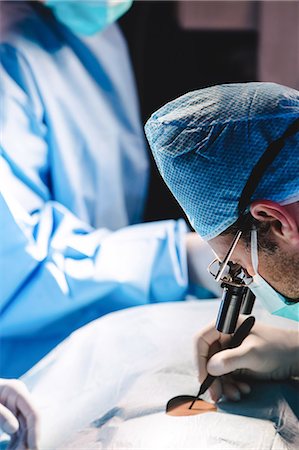 surgery team - Surgeons performing operation in operation room at the hospital Stock Photo - Premium Royalty-Free, Code: 6109-08720189