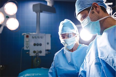 simsearch:400-06734621,k - Surgeons performing operation in operation room at the hospital Stock Photo - Premium Royalty-Free, Code: 6109-08720192