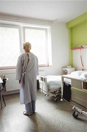 patient on bed for hospital - Senior woman standing in hospital ward Stock Photo - Premium Royalty-Free, Code: 6109-08720303