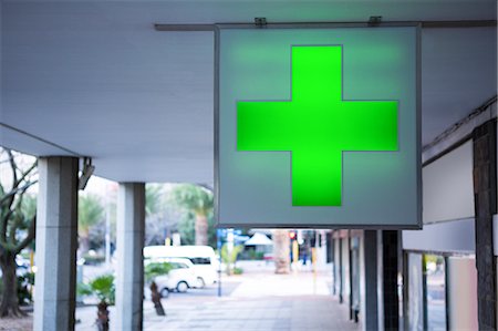 simsearch:6109-08689539,k - Medical cross sign outside pharmacy Stock Photo - Premium Royalty-Free, Code: 6109-08720484