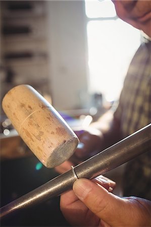 Close-up of goldsmith preparing work tool in workshop Stock Photo - Premium Royalty-Free, Code: 6109-08720407