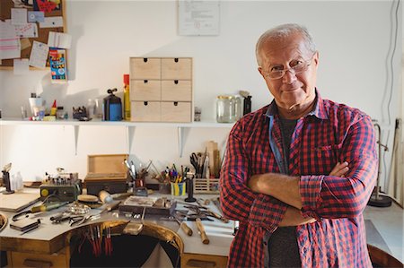 Portrait of goldsmith standing with arms crossed in workshop Stock Photo - Premium Royalty-Free, Code: 6109-08720425