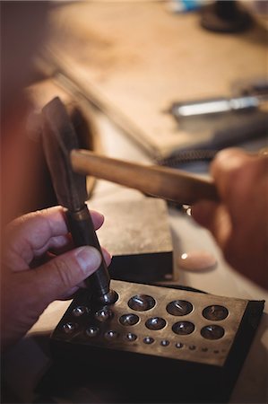 simsearch:6109-08720398,k - Close-up of goldsmith making hole in sinking at workshop Stock Photo - Premium Royalty-Free, Code: 6109-08720430