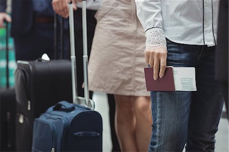 simsearch:400-08653702,k - Passengers holding passports and boarding pass waiting in queue inside the airport terminal Stock Photo - Premium Royalty-Free, Code: 6109-08722491