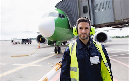 Portrait of airport ground crew standing on runway at airport terminal Stock Photo - Premium Royalty-Free, Code: 6109-08722685