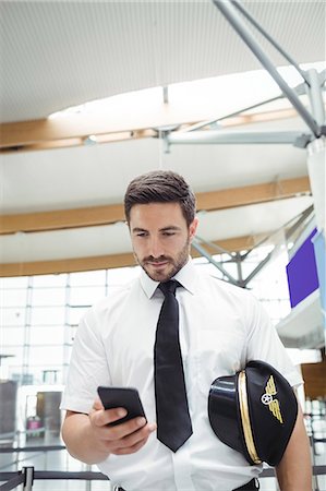 simsearch:693-06435879,k - Pilot using mobile phone in airport terminal Photographie de stock - Premium Libres de Droits, Code: 6109-08722741