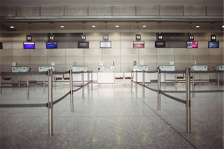 empty airport - Empty check-in counter inside the airport terminal Stock Photo - Premium Royalty-Free, Code: 6109-08722769