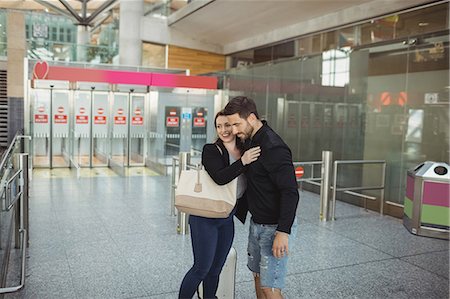 people hugging at airport - Couple embracing each other at airport Stock Photo - Premium Royalty-Free, Code: 6109-08722702