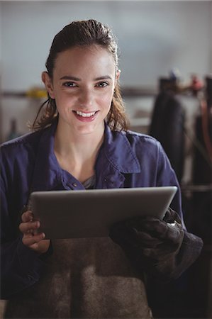 simsearch:6109-08722895,k - Portrait of female welder holding digital tablet in workshop Stock Photo - Premium Royalty-Free, Code: 6109-08722853