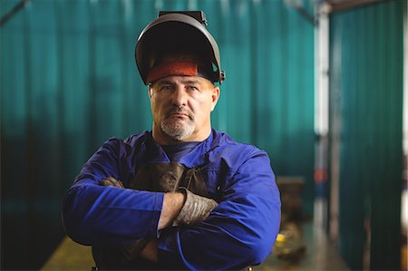 Portrait of male welder standing with arms crossed in workshop Stock Photo - Premium Royalty-Free, Code: 6109-08722907